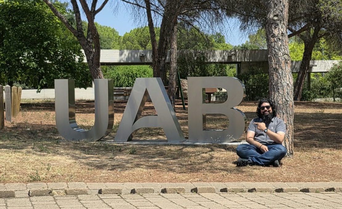 At the UAB sign on the Bellaterra campus